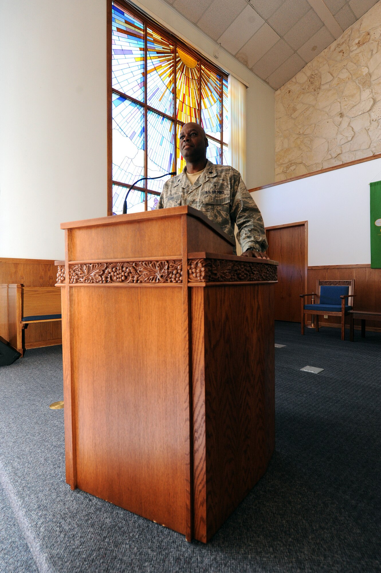 Chaplain (Lt. Col.) Clyde Dyson, the 341st Missile Wing command chaplain, poses for a picture behind his pulpit in the Malmstrom Air Force Base Chapel sanctuary. Dyson has been an Air Force chaplain for 17 years at nine bases and is scheduled to depart this fall. He will be replaced by Chaplain (Maj.) Mark Roberts who is currently serving as deputy wing chaplain for the 28th Bomb Wing at Ellsworth Air Force Base, S.D. (U.S. Air Force photo/Staff Sgt. R.J. Biermann)