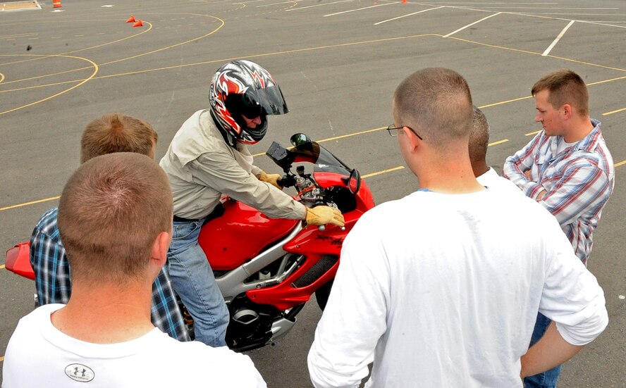 Keith Green, a Motorcycle Safety Foundation instructor, shows advanced riders course students proper motorcycle braking techniques on Barksdale Air Force Base, La., June 10, 2013. The MSF advanced riders course and basic riders course are mandatory requirements for active duty military to ride a motorcycle on or off base. Due to sequestration both MSF training courses will no longer be reimbursed beginning Aug. 15. (U.S. Air Force photo/Staff Sgt. Jason McCasland)