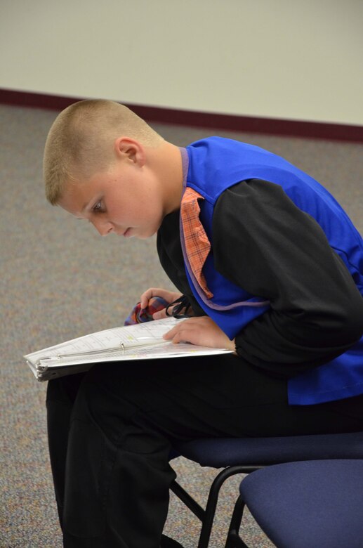 Hunter Plotkin, a member of Patrick AFB's Youth Center, studies his lines prior to the dress rehearsal of "Snow White and the Seven Dwarfs" July 26, 2013.  Plotkin, along with 55 other Air Force children, were part of the Missoula Children's Theater, a traveling theater company that spends a week at a time at locations throughout the United States bringing theater arts to local communities.  (U.S. Air Force photo by Susan A. Romano)
