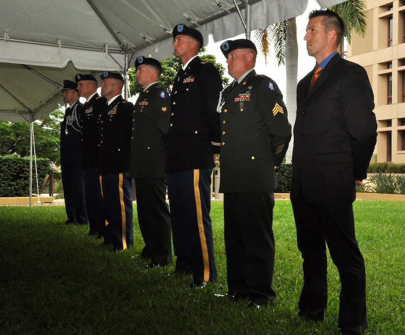 During an award ceremony at the U.S. Embassy in Tegucigalpa, U.S. personnel from both Joint Task Force-Bravo and the U.S. Embassy from right to left, Air Force Tech. Sgt. Logan Davis, JTF-Bravo Personnel Recovery Coordination Cell Survival, Evasion, Resistance and Escape specialist; Army Sgt. Travis Mayo, 1-228 Aviation Battalion flight medic; Warrant Officer Zachary Lungu, 1-228 Aviation Battalion pilot; Army Spc. Robert Clement, 1-228 Aviation Battalion crew chief, Chief Warrant Officer-3 Jay Hanshaw, 1-228 Aviation Battalion pilot, Col. Thomas D. Boccardi, JTF-Bravo commander; and Col. Lawrence Pravecek,  the Senior Defense Officer/Defense attaché, stand at  parade rest July 30, 2013.   On July 2, Davis, Mayo, Clement, Hanshaw, and Lungu were involved in saving the lives of two Americans, one Canadian and six Hondurans stranded in the Caribbean Sea for nearly four days.  