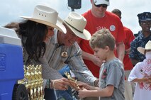 Wyoming Gov. Matt Mead and his wife pass out trophies to all the Challenge Rodeo contestants July 24, 2013, at Frontier Park, Cheyenne, Wyo. Challenge Rodeo is held Wednesday and Thursday during Cheyenne Frontier Days and is an event that pairs special-needs children with Professional Rodeo Cowboys Association rodeo contestants in a modified rodeo performance. (U.S. Air Force photo by Airman 1st Class Brandon Valle)