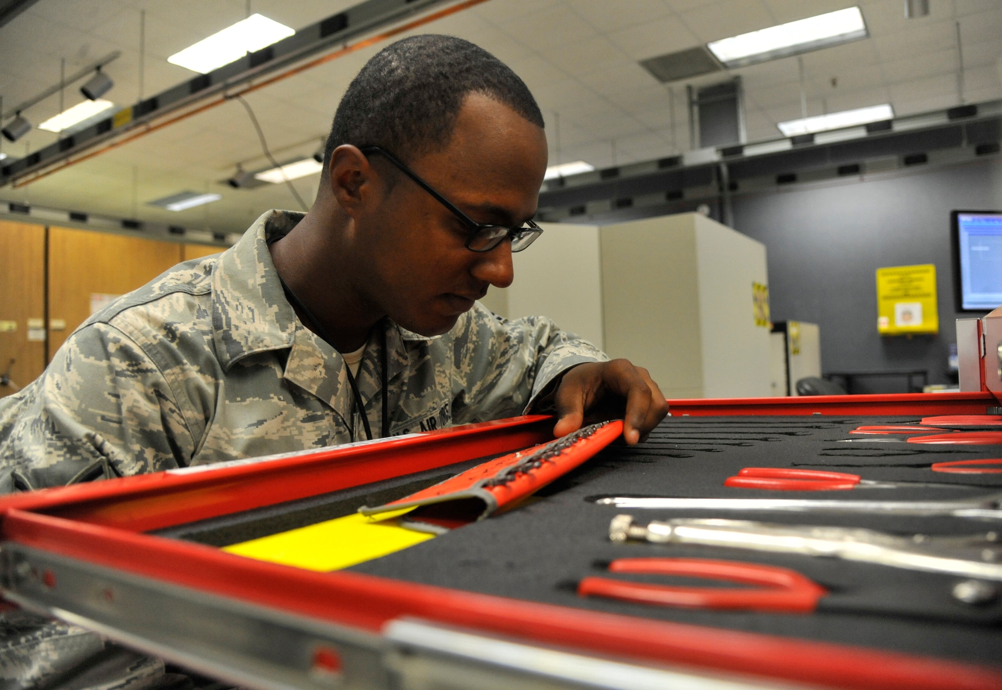Airman 1st Class Michael Touchette, 509th Maintenance Squadron avionics back shop team member, inspects a tap and die set at Whiteman Air Force Base, Mo., July 25, 2013. The tap and die set must be inspected to ensure there are no damaged or missing tools. These tools are used to rethread screws on line replaceable units and to prevent personality modules threads from stripping. (U.S. Air Force photo by Airman 1st Class Keenan Berry/Released)