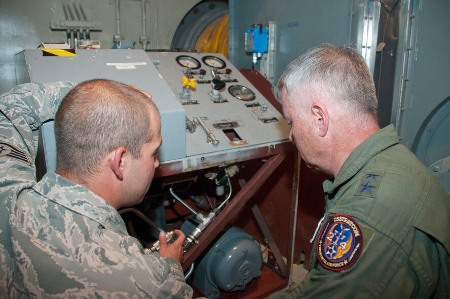 Staff Sgt. Aubrey Toney, 90th Maintenance Operations Squadron  Mechanical and Pneudraulic Shop, shows Maj. Gen. Michael Carey, 20th Air Force commander, the workings of a hydraulic pumping unit in the environmental control room of the Foxtrot-01 Missile Alert Facility July 29, 2013. (U.S. Air Force photo by Airman 1st Class Jason Wiese)