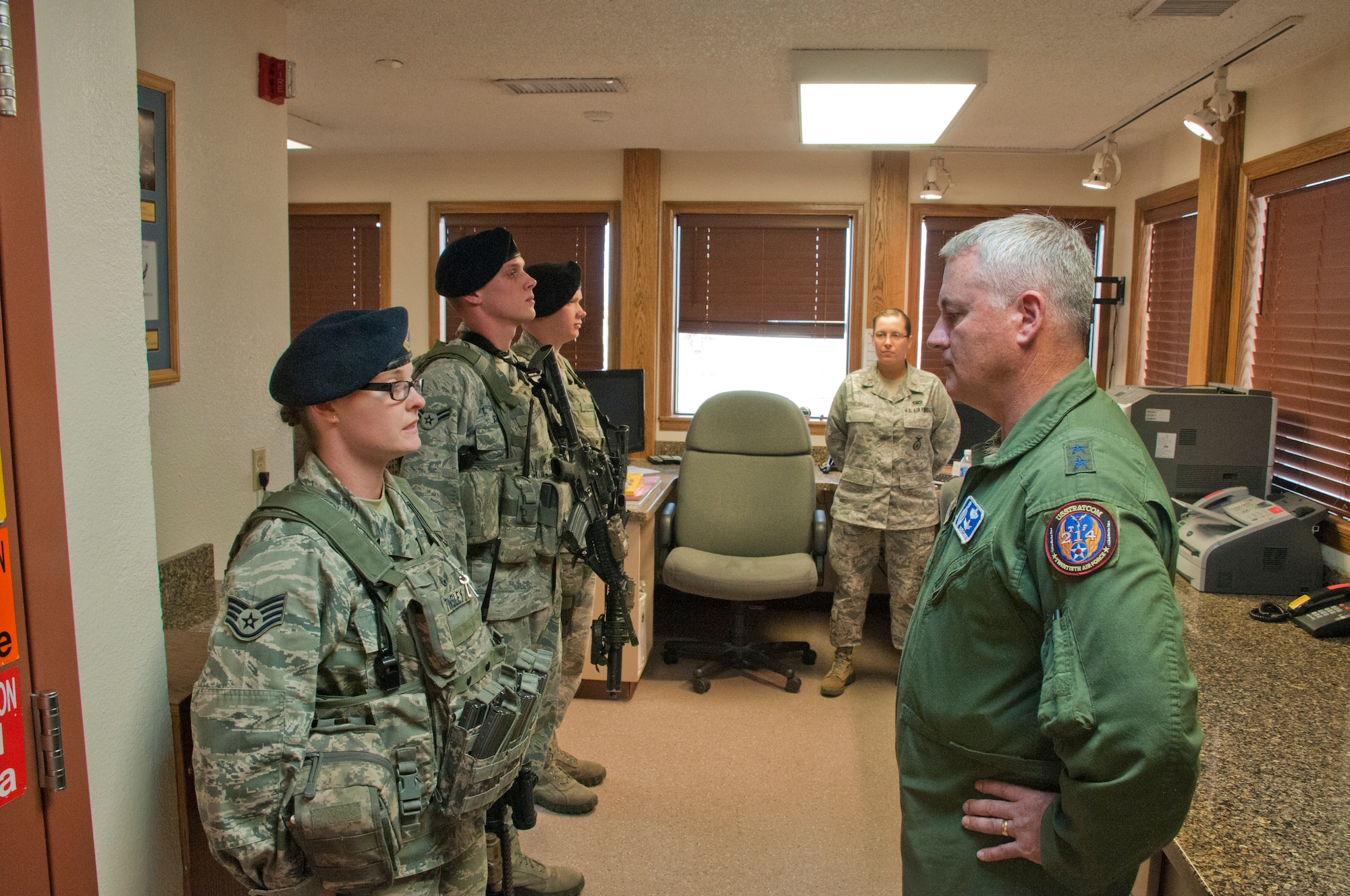 Staff  Sgt. Briana Tinsley, 90th Missile Security Forces Squadron flight security controller, gives a post brief to Maj. Gen. Michael Carey, 20th Air Force commander, while her troops await their turn to give a post brief July 29, 2013, in the Foxtrot-01 Missile Alert Facility. Carey toured the MAF and familiarized himself with concerns of the Airmen who work there. (U.S. Air Force photo by Airman 1st Class Jason Wiese)