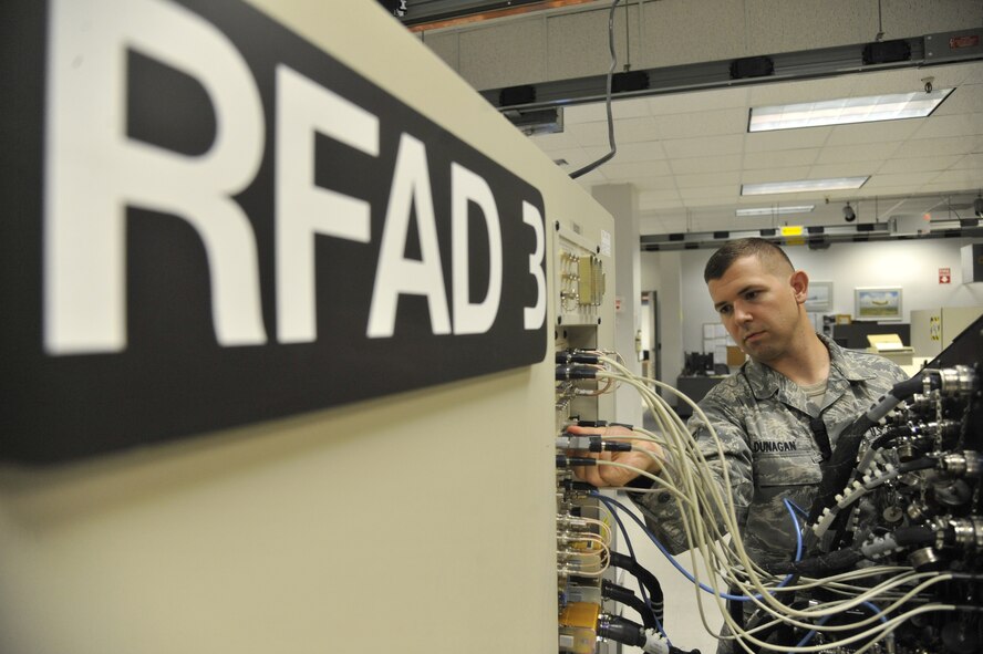 Staff Sgt. Reagan Dunagan, 509th Maintenance Squadron avionics back shop team leader, verifies the actuator remote terminal self-test setup connection at Whiteman Air Force Base, Mo., July 25, 2013. Avionics team members must make sure every cable between the test station and adaptor is properly connected before testing a line replaceable unit. (U.S. Air Force photo by Airman 1st Class Keenan Berry/Released)