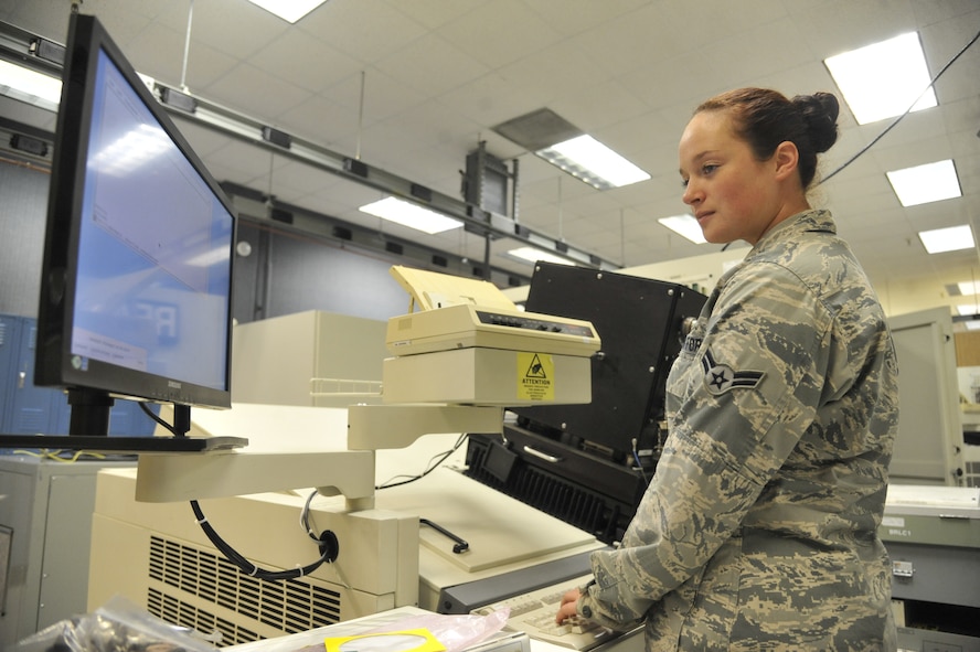 Airman 1st Class Samantha Bruton, 509th Maintenance Squadron avionics back shop team member, loads software for an actuator remote-terminal line-testing replaceable unit at Whiteman Air Force Base, Mo., July 25, 2013. Before the unit is used, it must be tested to ensure there are no system failures. If there are system failures, the avionics team will isolate the failed component from the test unit to prevent overall system failure. (U.S. Air Force photo by Airman 1st Class Keenan Berry/Released)