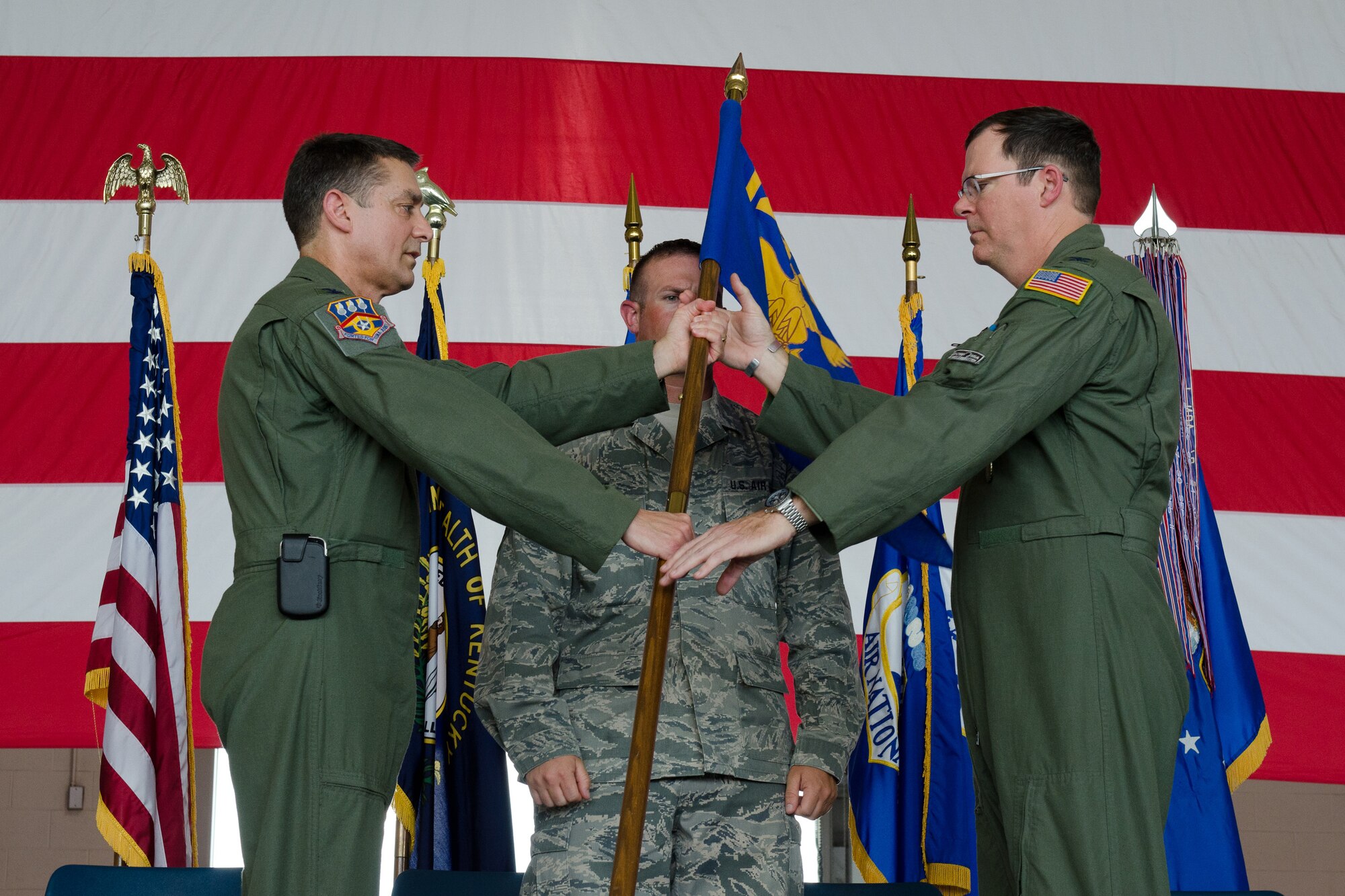 Col. Robert Hamm (right), incoming commander of the 123rd Operations Group, accepts the unit’s guidon from Col. Warren Hurst, commander of the 123rd Airlift Wing, during a change-of-command ceremony held at the Kentucky Air National Guard Base in Louisville, Ky., on June 22, 2013. Hamm previously served as vice commander of the 123rd Airlift Wing. (U.S. Air National Guard photo by Airman Joshua Horton)