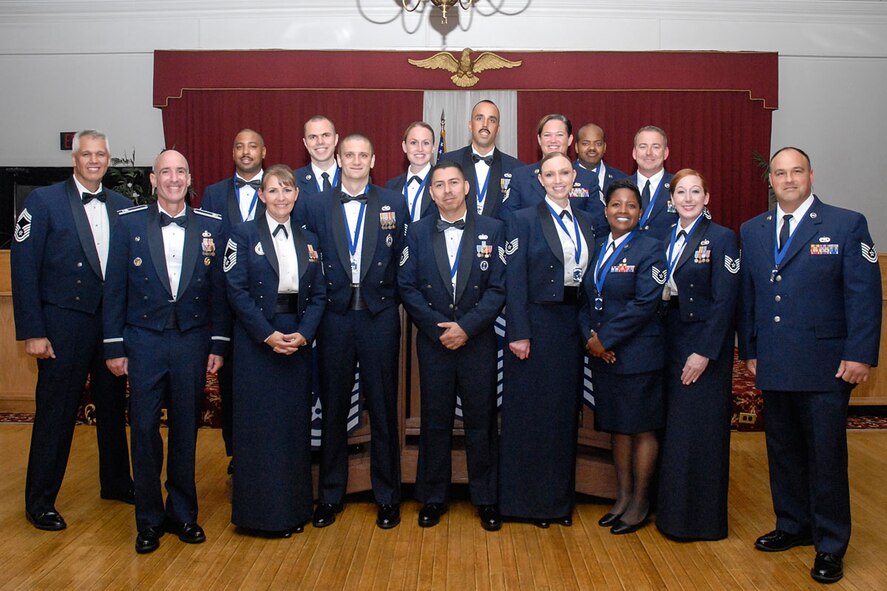 HANSCOM AIR FORCE BASE, Mass. -- Col. Lester A. Weilacher, 66th Air Base Group commander, and Chief Master Sergeants Mitchell K. Balutski and Kathleen M. McCool stand with newly inducted Senior NCOs during a ceremony at the Minuteman Commons July 26. Thirteen technical sergeants attended a three-day course on Senior NCO professional education that culminated with the banquet on the third day. (Courtesy photo)