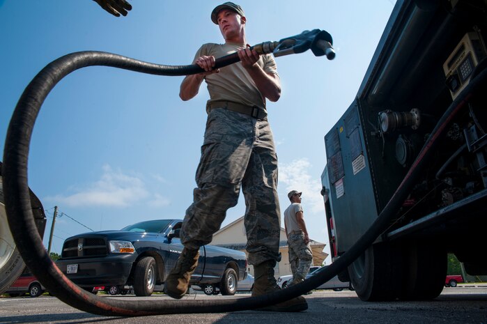 Senior Airman Mark Roth, 628th Logistics Readiness Squadron Petroleum Oil and Lubricants fuels specialist, prepares to hand a customer a fuel pump July 25, 2013, at Joint Base Charleston- Weapons Station, S.C. POL fuels supplies JB Charleston vehicles with fuel, including rail operations, cranes on Wharf Alpha to offload ships, port operations on the water, the 628th Security Forces Squadron and the U.S. Coast Guard. The 628th LRS has been providing this service since October 2010. A new service station is under construction at the Weapons Station and is scheduled to open later this year. (U.S. Air Force photo/Senior Airman Ashlee Galloway)