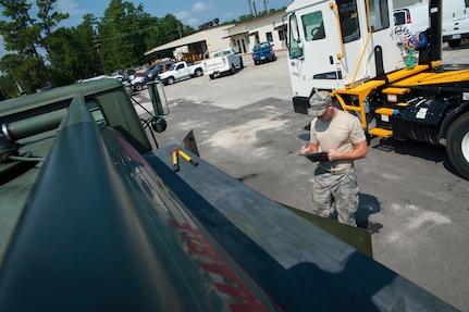 Senior Airman Mark Roth, 628th Logistics Readiness Squadron Petroleum Oil and Lubricants fuels specialist, records receipt information after refueling a vehicle July 25, 2013, at Joint Base Charleston- Weapons Station, S.C. Every Tuesday and Thursday, Airmen from the 628th LRS POL fuels from JB Charleston - Air Base, drive C-300 fuel trucks to the Weapons Station to service vehicles with motor oil gas or DS-2 diesel fuel. The 628th LRS has been providing this service since October 2010. A new service station is under construction at the Weapons Station and is scheduled to open later this year.  (U.S. Air Force photo/Senior Airman Ashlee Galloway)