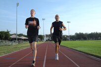 U.S. Air Force Capt. Adam Vannoy, Air Force Materiel Command program manager, and Lt. Col. Robert Vietas, 12th Flying Training Wing chief of inspections and instructor pilot, train for a marathon July 25 at Joint Base San Antonio-Randolph  Vannoy and Vietas will represent the Air Education and Training Command team at the Air Force Marathon Sept. 21. (U.S. Air Force photo by Joel Martinez/Released)