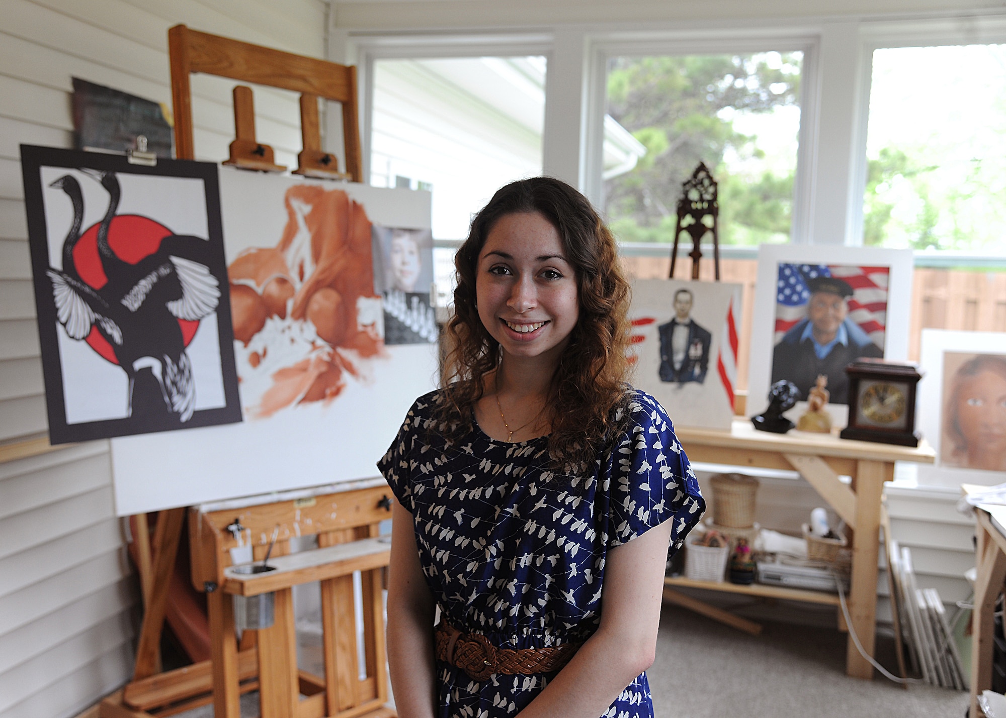 Natalie Michelle Mann poses in her home art studio, June 1, 2013, on Grand Forks Air Force Base, N.D. Natalie started painting when she was a junior in high school and plans to attend Columbus College of Art and Design through her scholarship awarded to her as a result of her numerous works and potential. (U.S. Air Force Photo/Airman 1st Class Zachiah Roberson)