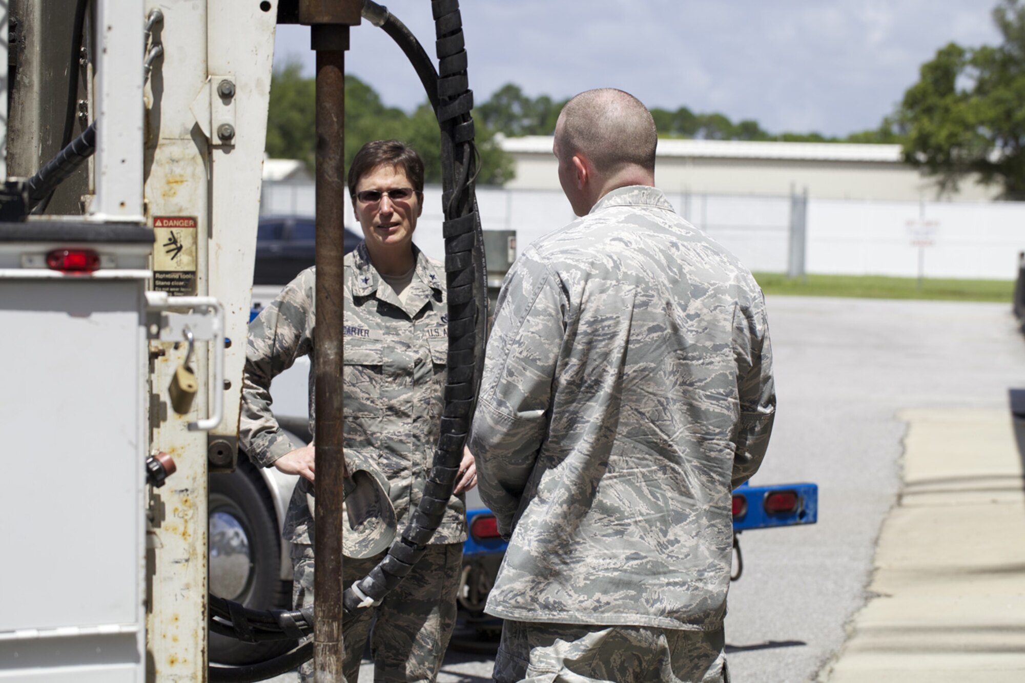 TYNDALL AIR FORCE BASE, Fla. -- Brig. Gen. Theresa Carter, the Air Force Civil Engineer, talks with Maj. Timothy Grady, Airfield Pavement Evaluation team chief, during a visit to Det. 1, Air Force Civil Engineer Center here July 31. In addition to developing guidance and providing technical support to Air Force installations, AFCEC’s APE division tests strength and friction characteristics at airfields around the world to assist the Air Force in sustaining flight capabilities. Carter’s trip to AFCEC marked the first since she was named the Civil Engineer in June. (U.S. Air Force photo/Eddie Green)