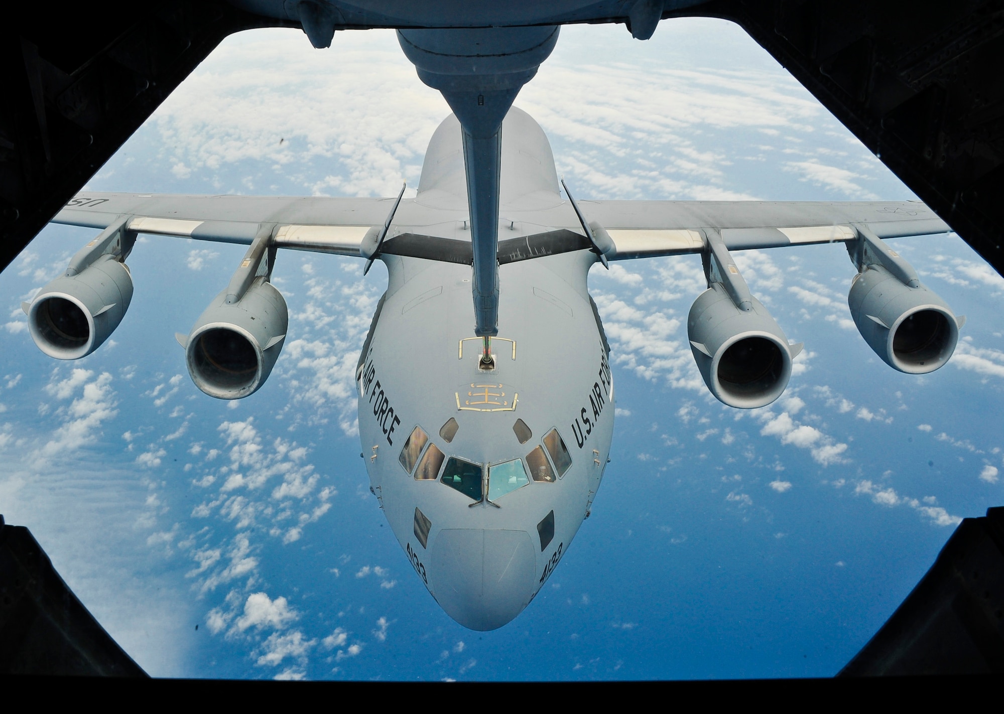 Airman 1st Class Will Gribauskas, 2nd Air Refueling Squadron boom operator, connects the probe to a 6th Airlift Squadron C-17 Globemaster III during a training sortie July 29, 2013, in the skies above the Atlantic. “Like any skill, boom operating requires practice to maintain your abilities,” said Gribauskas. “I’m still in training so my skill level is always increasing.” (U.S. Air Force photo by Airman 1st Class Ryan Throneberry/Released)