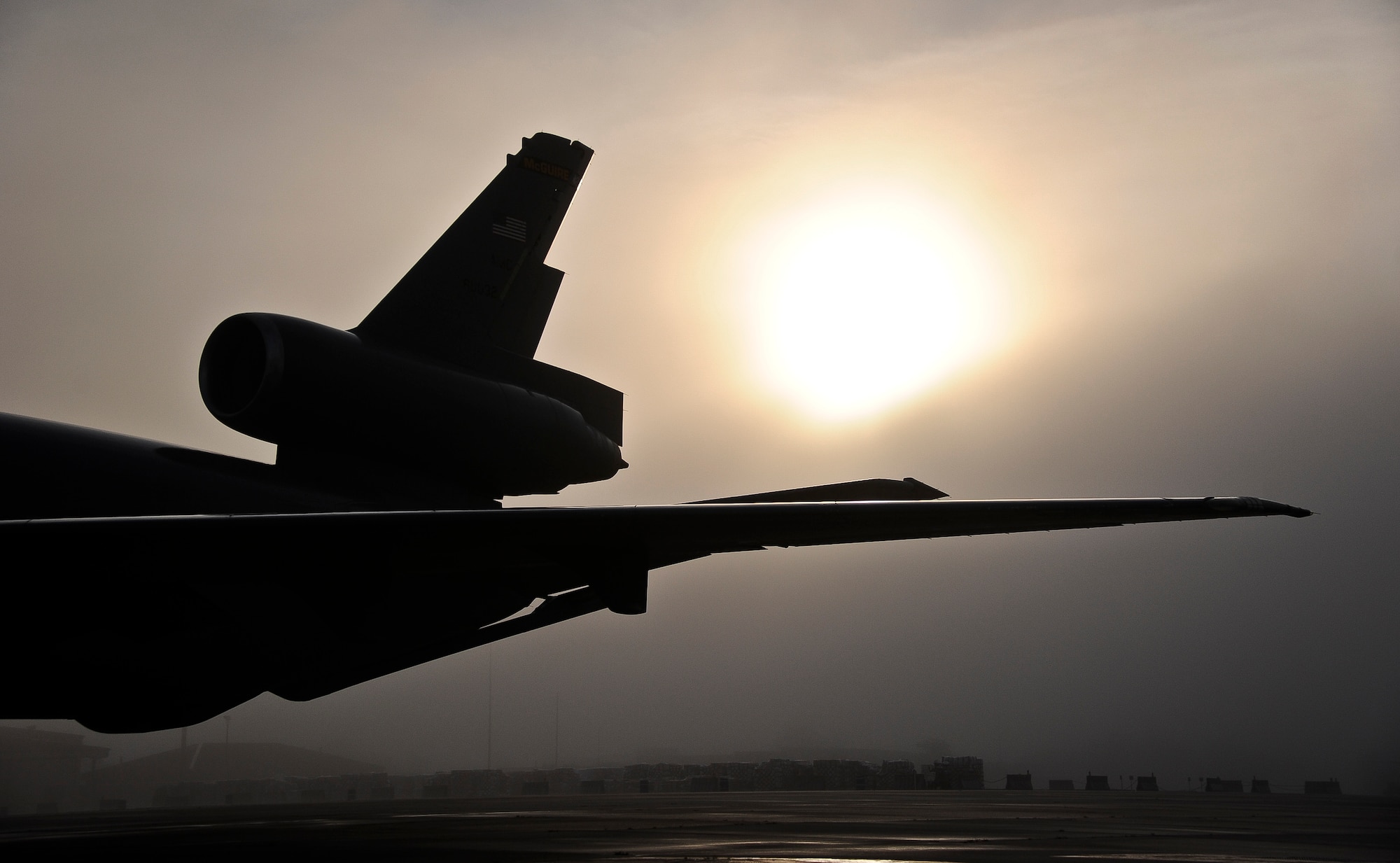 The sun rises on McGuire Field as a KC-10 Extender crew prepares for an air refueling training sortie July 29, 2013, at Joint Base McGuire-Dix-Lakehurst, N.J. Training sorties enable the crew members to polish their skills before using them in deployed environments. (U.S. Air Force photo by Airman 1st Class Ryan Throneberry/Released)