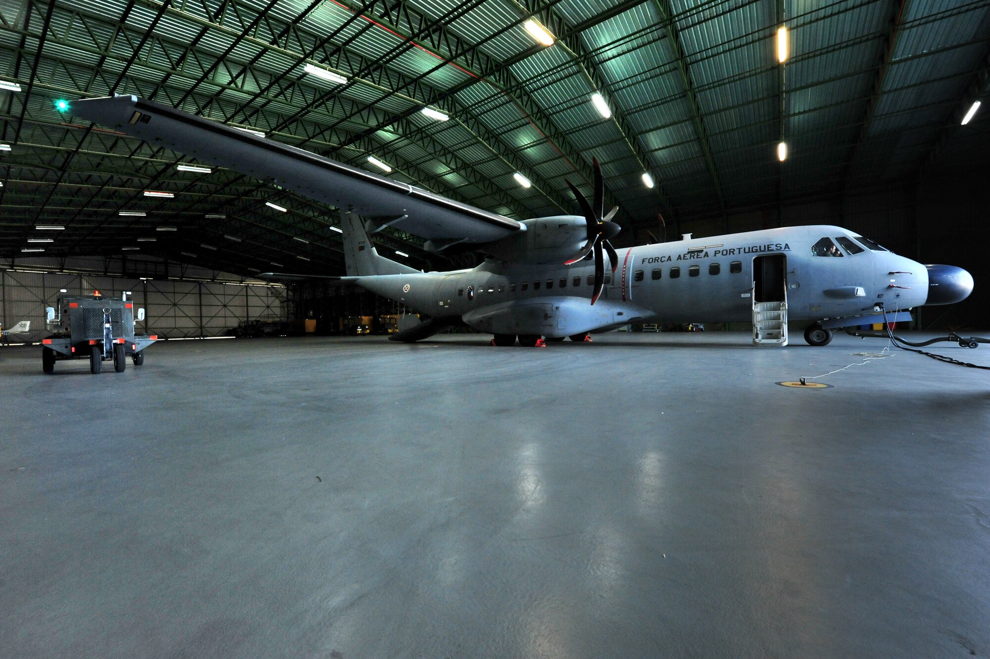 A Casa C-295M Twin-Turboprop Transport aircraft in a hangar at Portuguese Air Base 4, commonly known as Lajes Field.  Since the beginning of 2012, Portuguese aircraft operating from Lajes Field have combined for 232 search and rescue missions, coming to the aid of 252 people.  When executing search and rescue missions, these aircraft count on American fuel pumped by the 65th Logistics Readiness Squadron Fuels Management Flight.   (U.S. Air Force photo by Tech. Sgt. Chenzira Mallory/released)