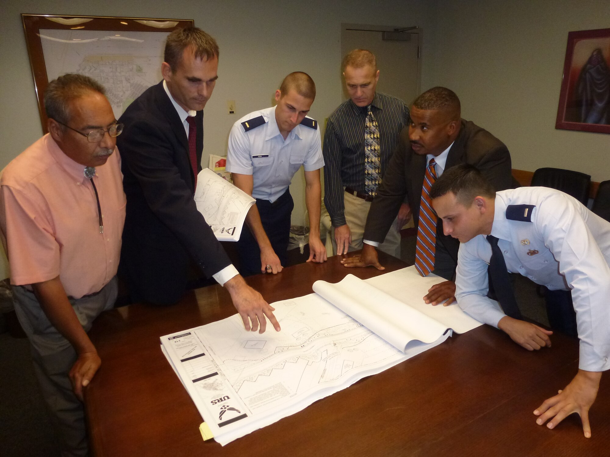 LAUGHLIN AIR FORCE BASE, Texas -- From left, Jerry Garcia, David Morin, Lt. Charles Heim, Perry Benton, Eric Guess, and Lt. Christian Ocasio review plans for a 221-acre xeriscape project here. Base Energy Manager David Morin's leadership on projects such as this one earned him a 2013 Federal Energy Management Program Award. Xeriscaping is the use of rocks and mulch in varying sizes and textures along with drought tolerant plants to  replace the need for grass, water and maintenance. (U.S. Air Force photo/MSgt Michael McComas