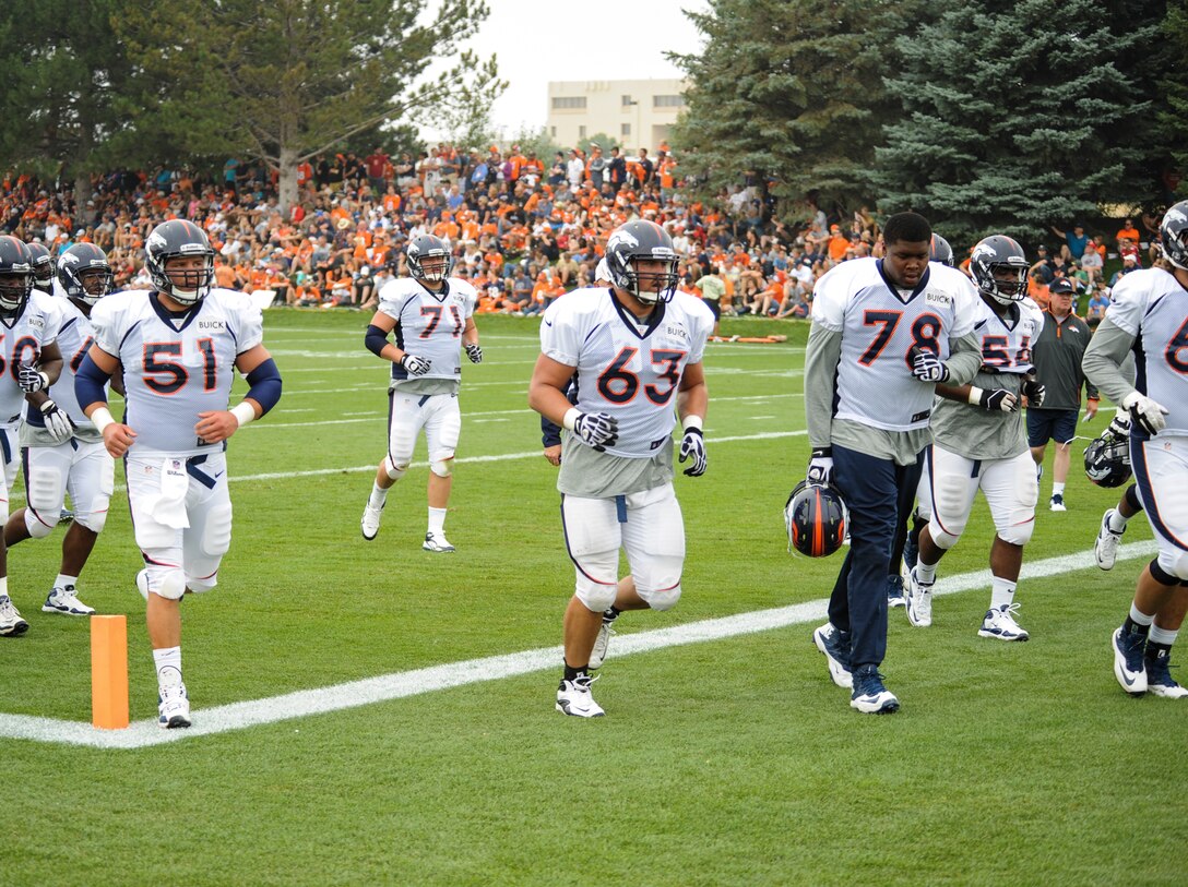 Benjamin Garland, Denver Broncos offensive guard, 63, runs to the next drill with the rest of his offensive line members during a Broncos training camp practice July 29, 2013, at the Broncos training facility, Englewood, Colo. Garland spent last season on the Broncos practice squad and transitioned from defensive tackle to offensive guard before the Broncos 2013 mini-camp. Garland is also a first lieutenant for the 140th Wing, Colorado Air National Guard, and served his annual commitment during the early part of 2013. (U.S. Air Force photo by Staff Sgt. Christopher Gross/Released)