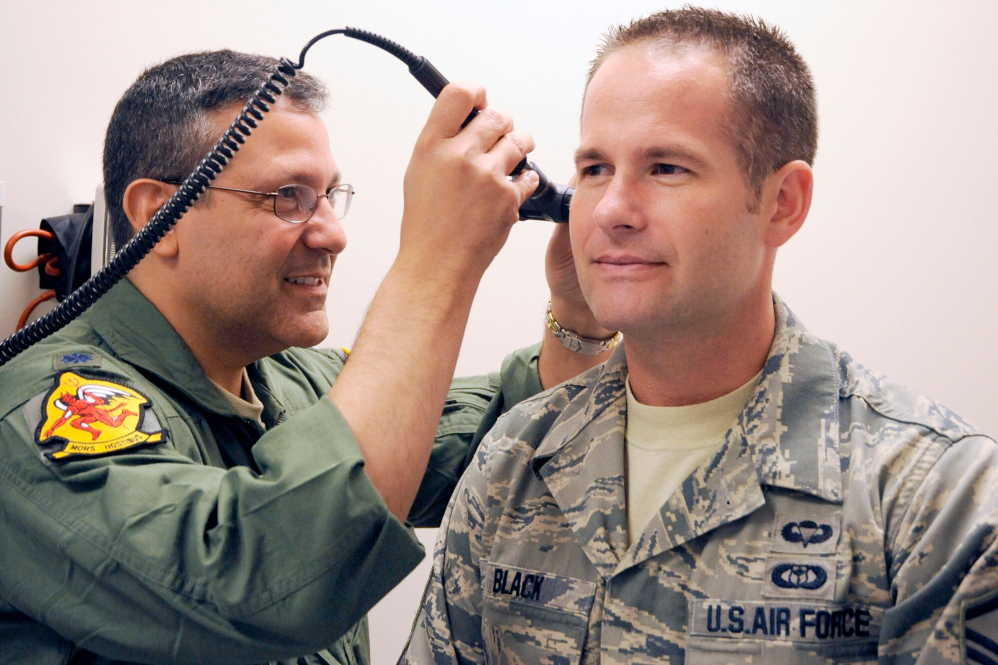 130725-Z-HC784-041 – Lt. Col. Dr. Ralph Torres, a physician with the 127th Medical Group, performs an ear examination on Master Sgt. Kyle Black at Selfridge Air National Guard Base, July 25, 2013. The 127th Medical Group is charged with maintaining the medical readiness of nearly 1,700 Citizen-Airmen in the Michigan Air National Guard. (U.S. Air National Guard photo by John S. Swanson/Released)