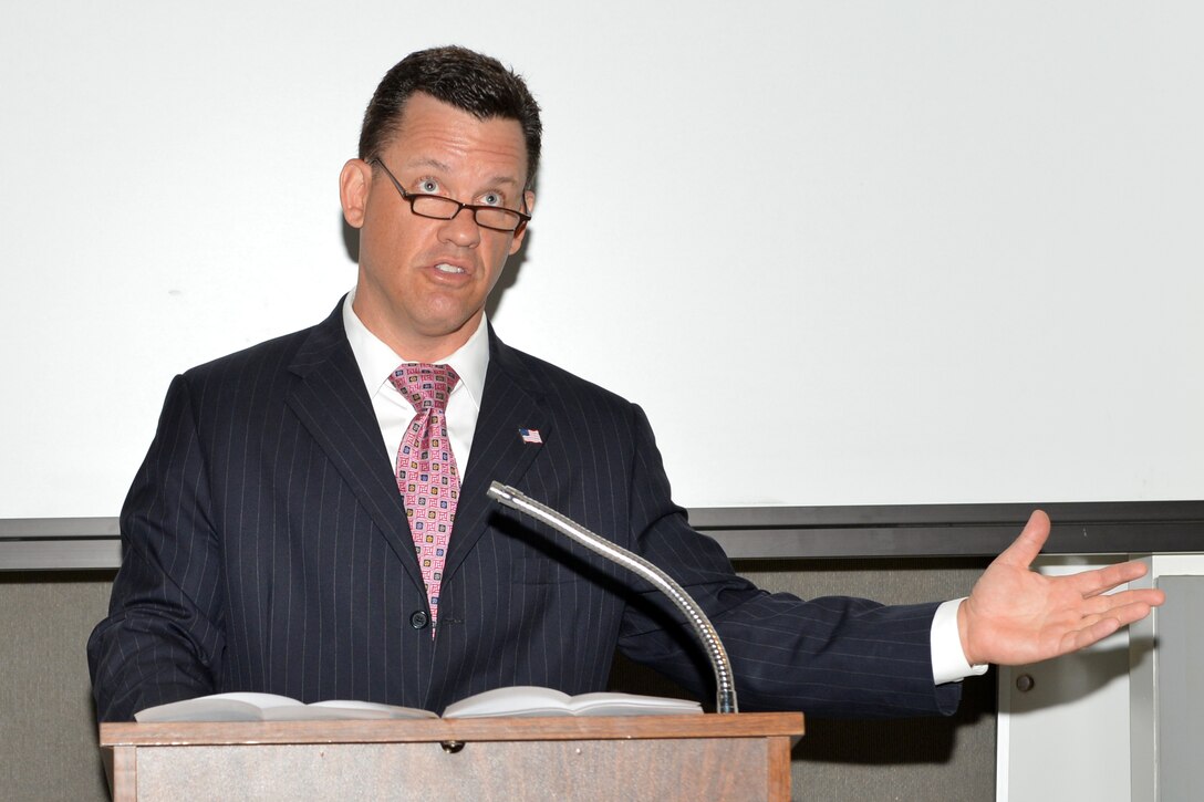 Nebraska Attorney General, Jon Bruning, briefs members of the Nebraska Air and Army National Guard on consumer protection during Military Consumer Protection Day, at the Nebraska National Guard air base, July 17, 2013. Bruning provided resources and advice on how to avoid being a victim of identity theft and fraudulent financial activity. 