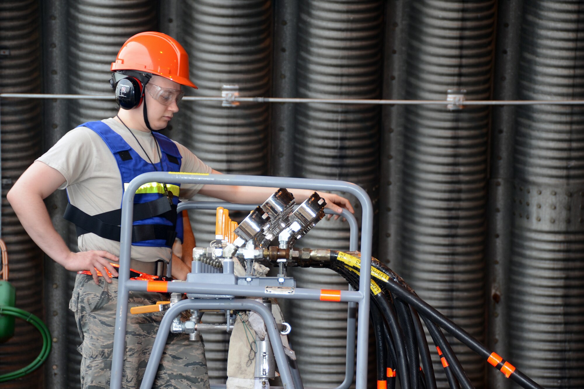 Senior Airman Aubrey Berger, 48th Equipment Maintenance Squadron repair and reclamation journeyman, observes air pressure readings during crash recovery lift training at Royal Air Force Lakenheath, England, July 27, 2013. The Airmen lifted an F-15C Eagle with high-capacity air bags as part of their annual training requirement to prepare for assisting with potential aircraft recovery operations. (U.S. Air Force photo by Airman 1st Class Trevor T. McBride/Released)