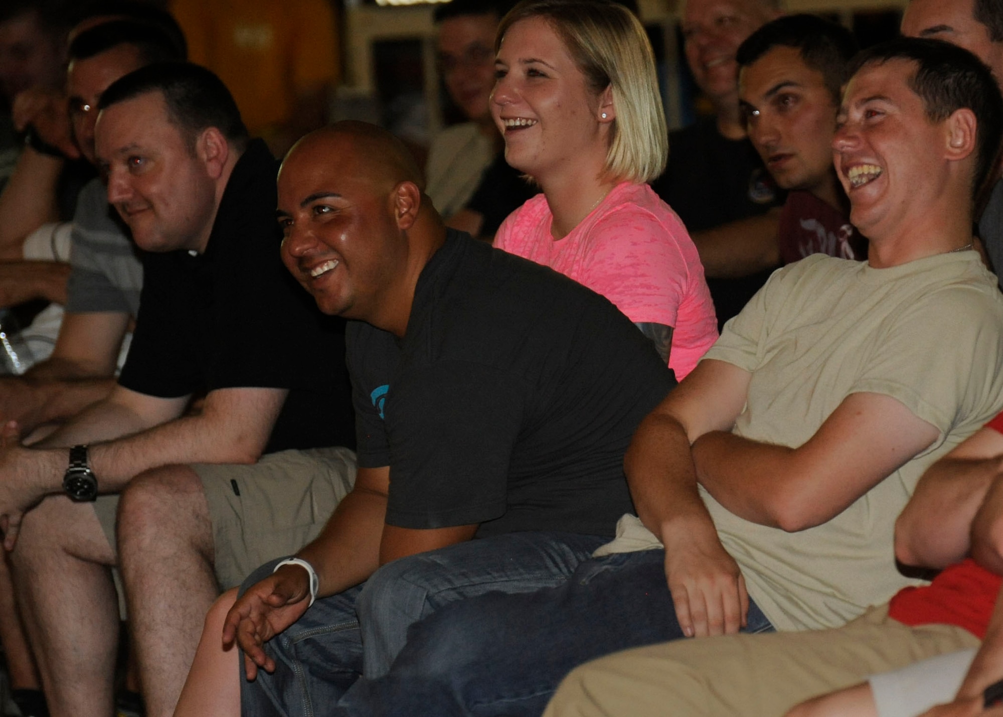 Deployed service members enjoy a laugh during Don Barnhart’s All-Star Comedy tour performance presented by Armed Forces Entertainment at the 379th Air Expeditionary Wing in Southwest Asia, July 28, 2013. AFE is the official Department of Defense agency for providing entertainment to U.S. military personnel overseas and hosts more than 1,200 shows around the world, reaching more than 500,000 personnel at 270 military installations. (U.S. Air Force photo/Senior Airman Bahja J. Jones) 
