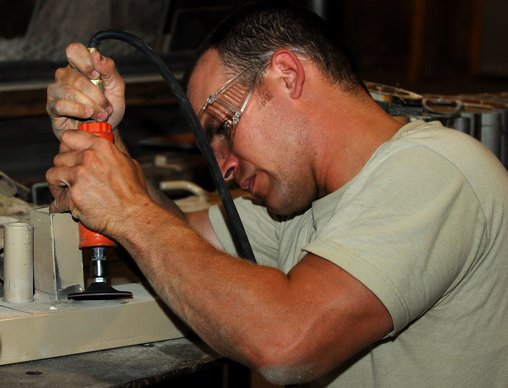 Tech. Sgt. Richard Vagnoni, 809th Expeditionary Rapid Engineer Deployable Heavy Operational Repair Squadron aircraft metals technician, repairs a piece from a broken tent at Kandahar Airfield, Afghanistan July 24, 2013. Metals tech. Airmen often repair simple and complex metal pieces in order to accommodate mission requirements. Vagnoni is deployed from Nellis Air Force Base, Nev. (U.S. Air Force photo by Senior Airman Jack Sanders)