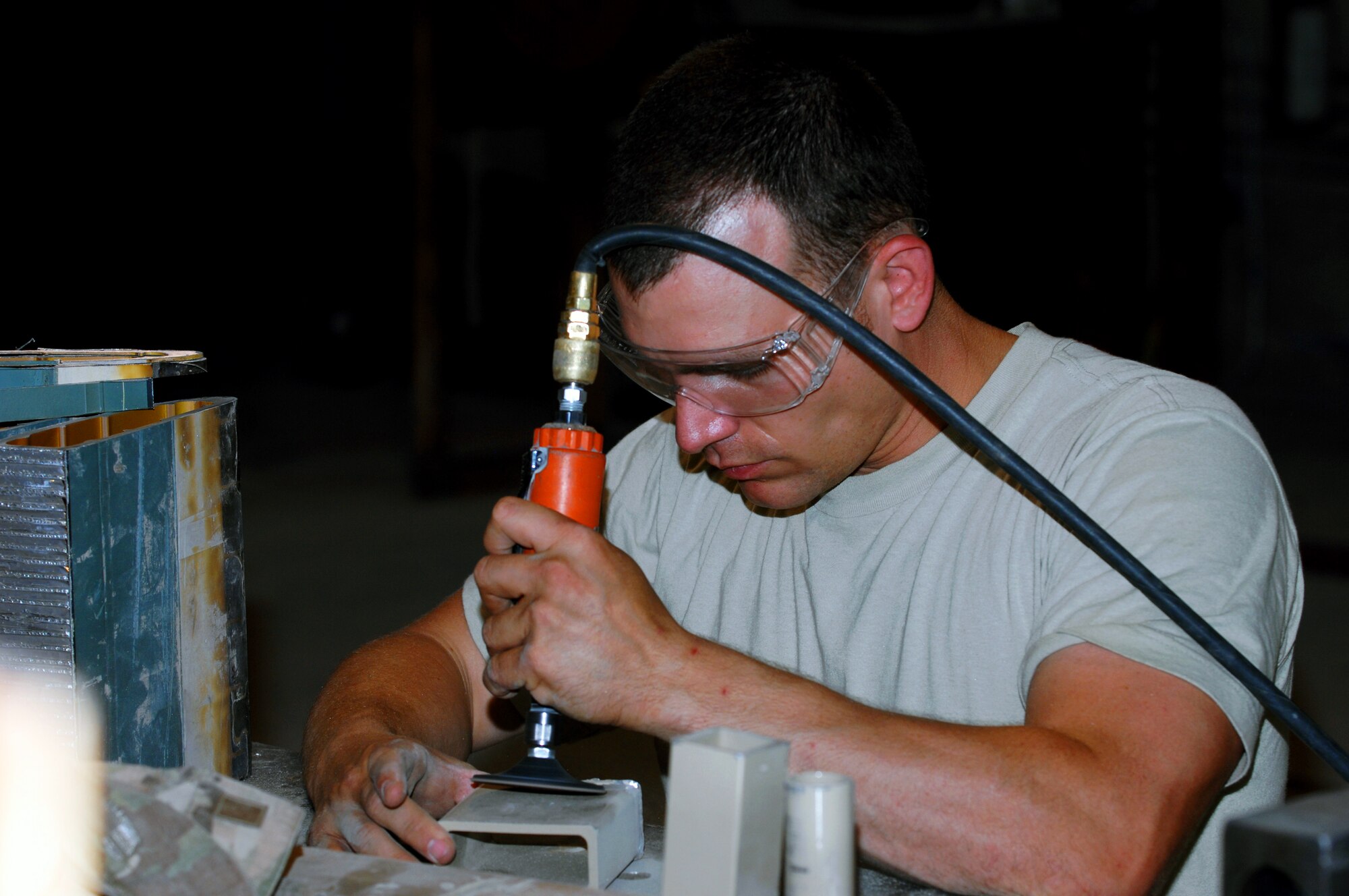Tech. Sgt. Richard Vagnoni, 809th Expeditionary Rapid Engineer Deployable Heavy Operational Repair Squadron aircraft metals technician, repairs a piece to a broken tent at Kandahar Airfield, Afghanistan, July 24, 2013. Metals tech. Airmen often repair simple and complex metal pieces to accommodate the needs of the mission. Vagnoni is deployed from Nellis Air Force Base, Nev. (U.S. Air Force photo by Senior Airman Jack Sanders)