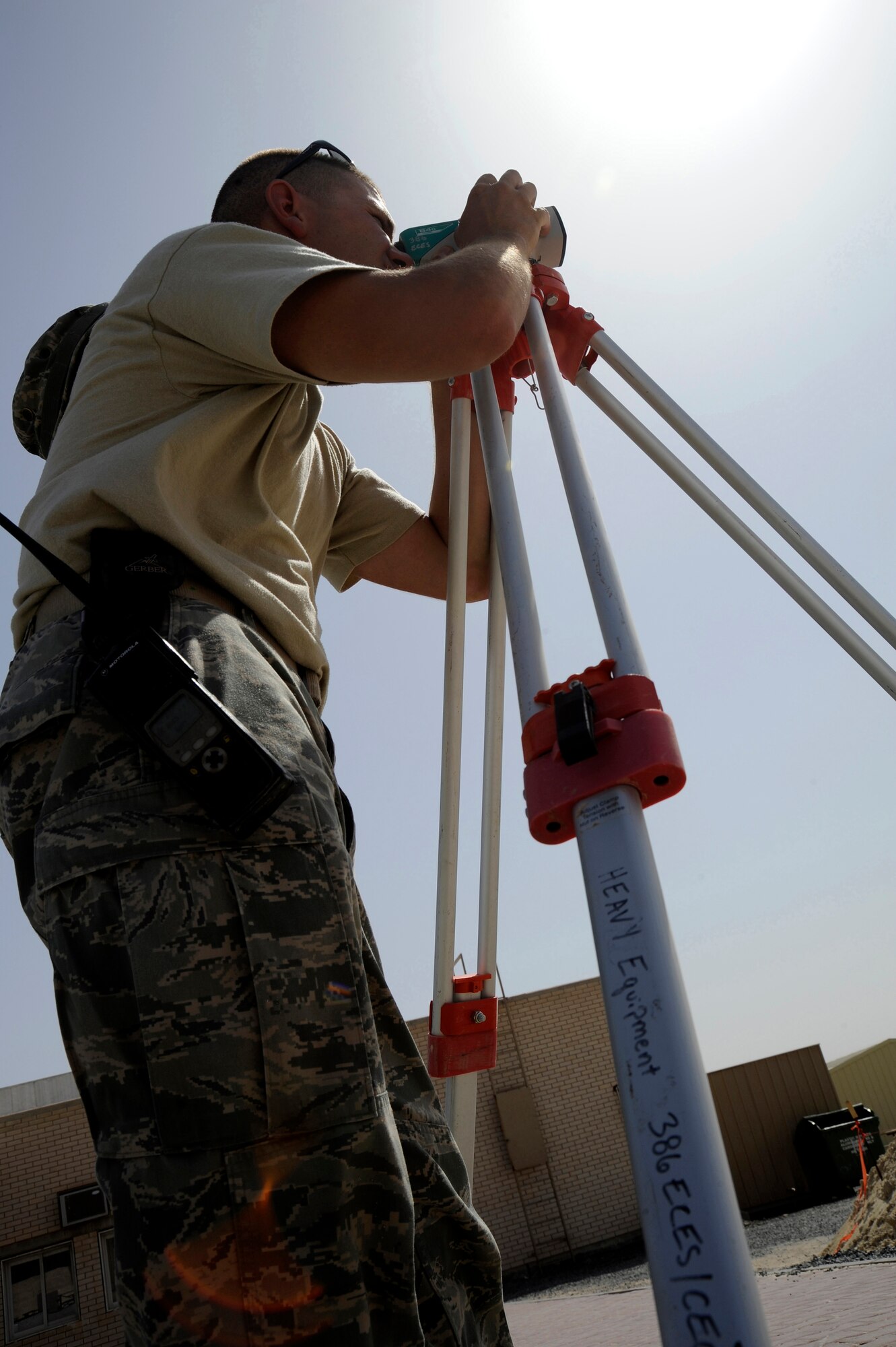 Tech. Sgt. Mark Ondersma, 386th Expeditionary Civil Engineer Squadron, heavy equipment operator, looks through an auto leveler here, July 29, 2013. Ondersma is the project manager for this site and needs to make sure all the base material or gatch is level. Ondersma is deployed out of the 110th Airlift Wing, Battle Creek, Mich., Air National Guard unit. (U.S. Air Force photo by Master Sgt. Christopher A. Campbell)