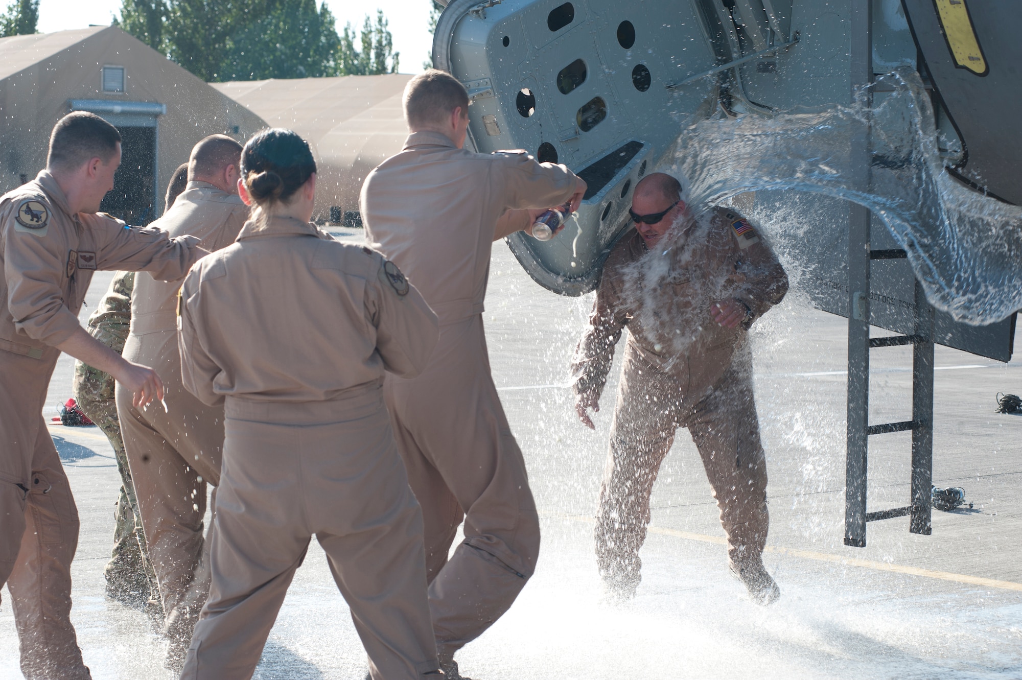 Capt. Brent Helinski, 22nd Expeditionary Air Refueling Squadron, is splashed, poured on and sprayed by various beverages in celebration at Transit Center at Manas, Kyrgyzstan. Helinski had just completed his 500th combat/combat support sorti in a KC-135 Stratotanker. (U.S. Air Force photo/Staff Sgt. Robert Barnett)