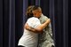 Miriam Hamilton, widow of U.S. Air Force Capt. Nathan Nylander, hugs U.S. Air Force Master Sgt. Chris Banks, a medical technician with the 55th Medical Operations Squadron, July 19 at the Air Force Weather Agency at Offutt Air Force Base, Neb. Banks was deployed to Afghanistan and risked his own life to provided medical triage to Nylander as well as other wounded Airmen following the shooting at Kabul International Airport on April 27, 2011. (Photo by Josh Plueger)