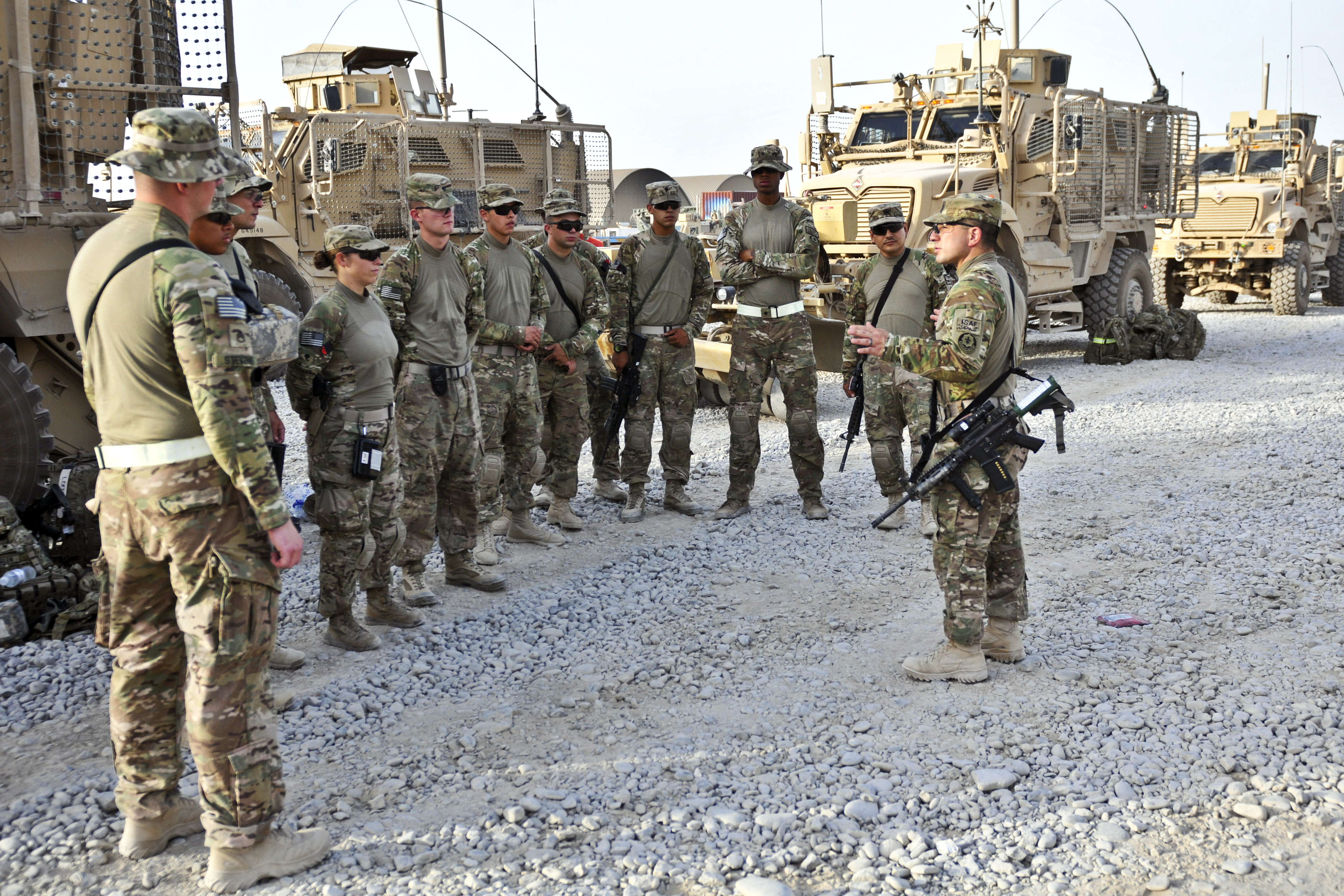 U S Army Sgt 1st Class Jason Alaniz right gives a mission brief to