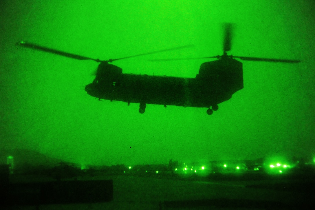 As seen through a night-vision device, a CH-47 Chinook helicopter begins night missions on Forward Operating Base Fenty in Nangarhar province, Afghanistan, July 22, 2013.