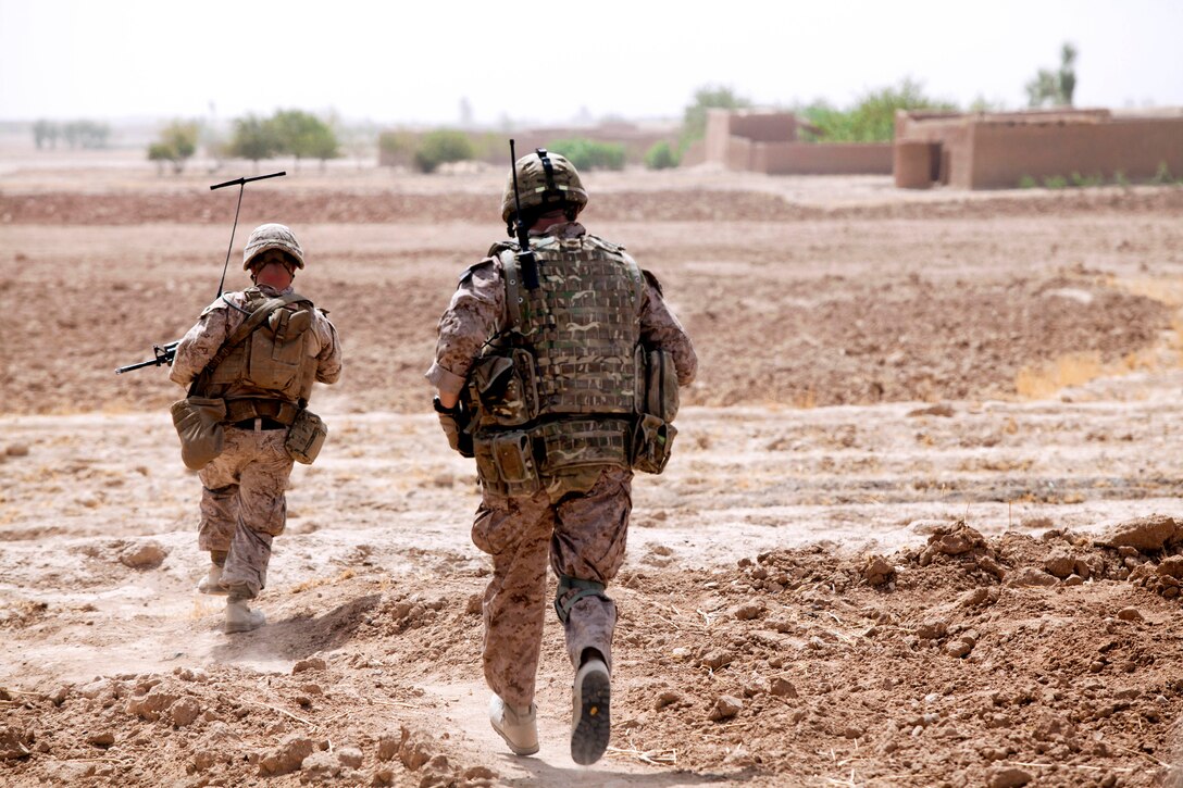U.S. Marine Corps Sgt. Joshua Farrell, left, and British Lance Cpl. Thomas Bailey move toward the enemy after taking fire during Operation Grizzly in Helmand province, Afghanistan, July 18, 2013. Farrell and Bailey, a member of the British air force, are assigned to Fox Company, 2nd Battalion, 2nd Marine Regiment.

