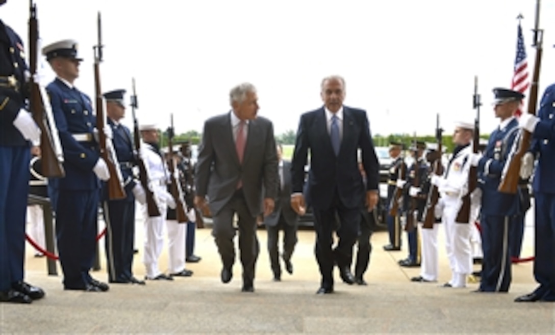 Secretary of Defense Chuck Hagel, left, escorts Greece’s Minister of National Defense Dimitris Avramopoulos, right, through an honor cordon and into the Pentagon in Arlington, Va., on July 30, 2013.  Hagel, Avramopoulos and their senior advisors will meet to discuss national security items of interest to both nations. 