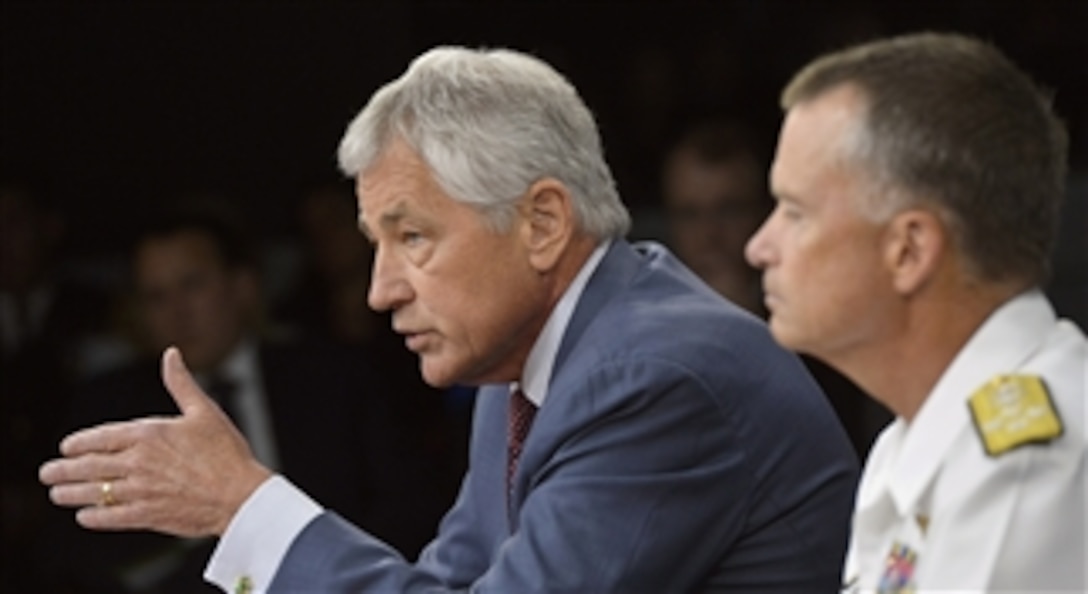 Secretary of Defense Chuck Hagel, left, answers a reporter’s question during a Pentagon press briefing on the recent Strategic Choices Management Review in Arlington, Va., on July 31, 2013.  Vice Chairman of the Joint Chiefs of Staff Adm. James Winnefeld Jr. joined Hagel for the briefing.  The purpose of the review was to understand the impact of further budget reductions on the Department, and develop options to deal with these additional cuts.  