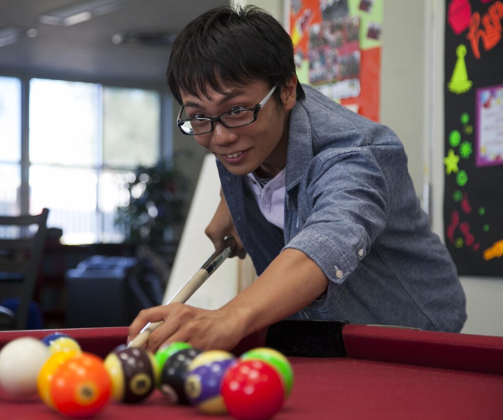Itsuki Otani plays pool as part of the 3rd annual Oshima youth cultural exchange program July 31 at the Kishaba Youth Center on Camp Foster. The program brings teens affected by the 2011 earthquake and tsunami from Oshima Island to Camp Foster to experience American culture. The participants are students between the ages of 13 and 18 years old. For some, this year’s exchange marks their second or third year participating in the exchange. Otani is a 17-year-old participant in the program. (U.S. Marine Corps photo by Lance Cpl. Natalie M. Rostran/Released)
