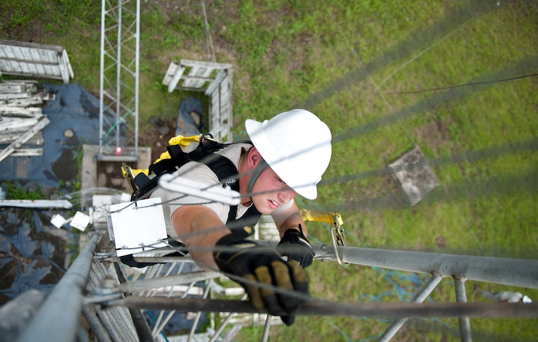 Airman 1st Class Mike Turland climbs the stand to a rotatable log periodic antenna during scheduled maintenance July 26, 2013, at the Tokorozawa Communications Site, Japan. Turland wears a safety harness to prevent the possibility of falling and ensures he has three points of contact throughout the climb. Turland is a cable and antenna maintenance technician assigned to the 374th Communications Squadron. (U.S. Air Force photo/Senior Airman Cody H. Ramirez)