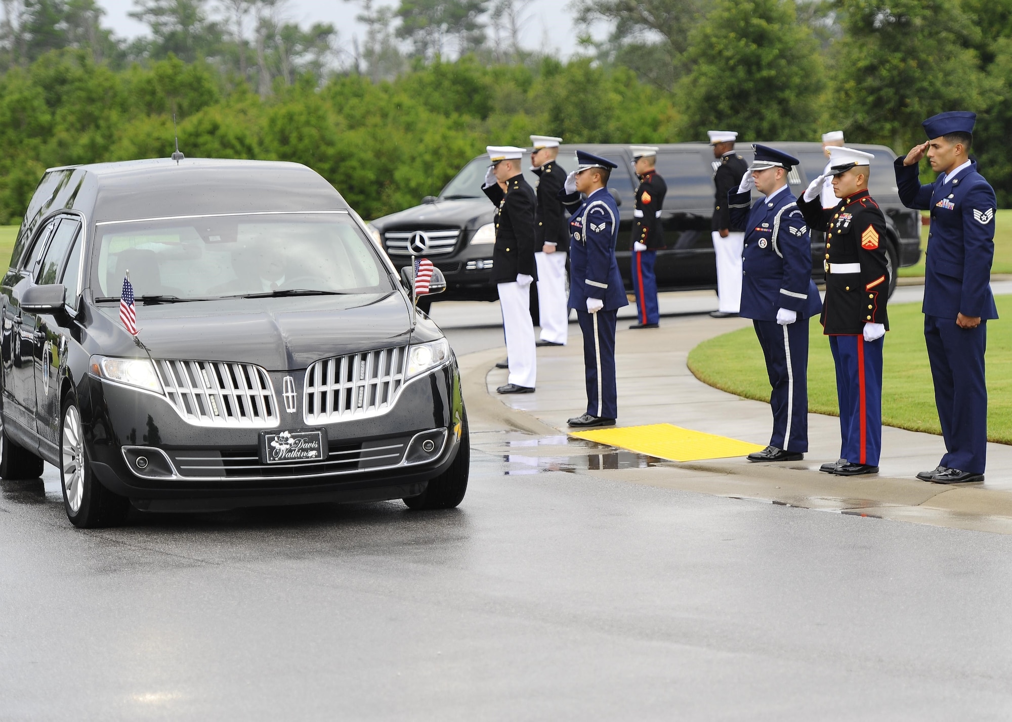 Service members salute retired U.S. Air Force Col. George “Bud” Day’s hearse as it arrives to Barrancas National Cemetery on Naval Air Station Pensacola, Fla., Aug. 1, 2013. Day, a Medal of Honor recipient and combat pilot with service in World War II, Korea and Vietnam, passed away July 27 at the age of 88. (U.S. Air Force Photo/Airman 1st Class Jeffrey Parkinson) 