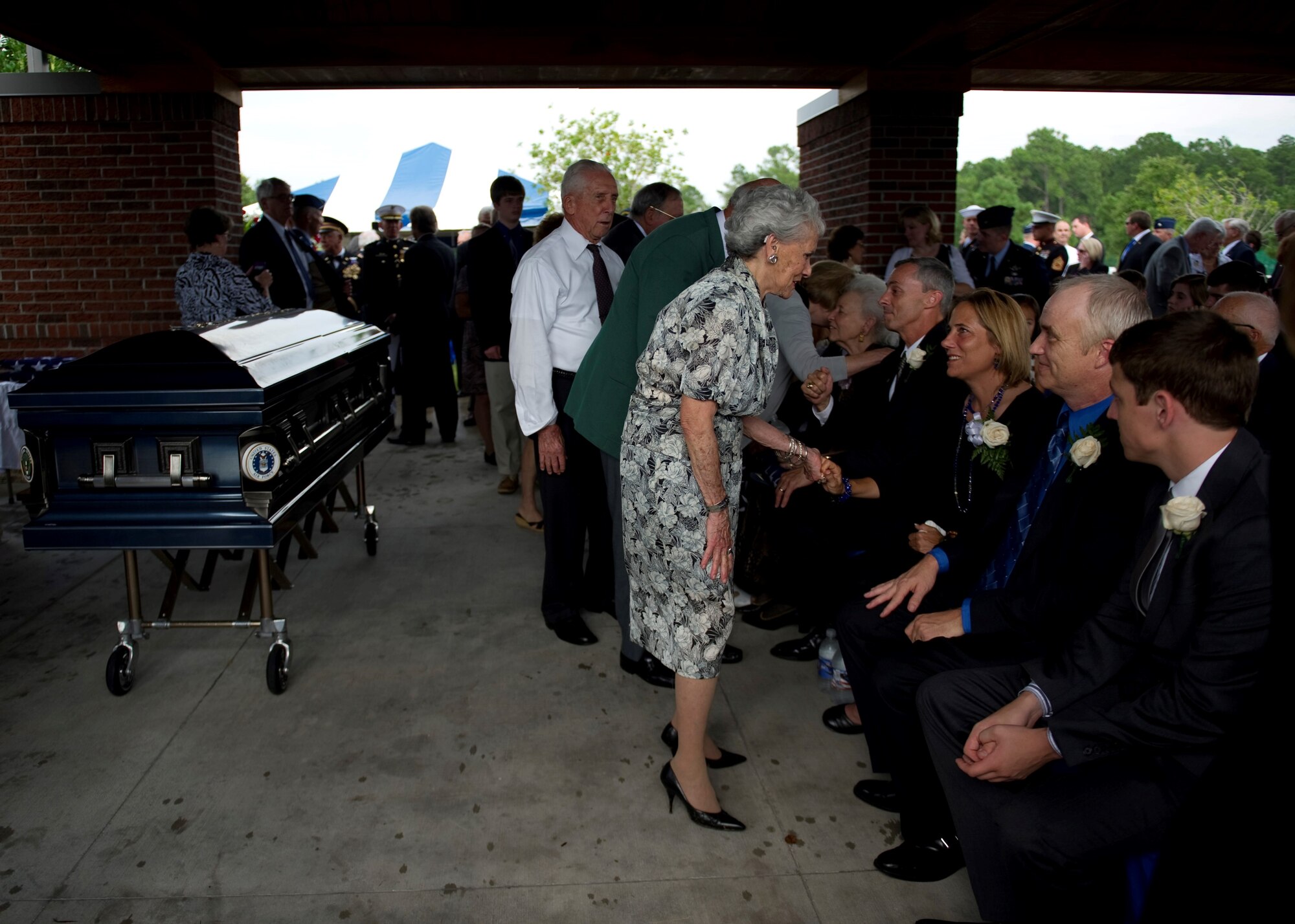 Guests pay their final respects to retired U.S. Air Force Col. George “Bud” Day’s family upon the conclusion of his funeral service at Barrancas National Cemetery on Naval Air Station Pensacola, Fla., Aug. 1, 2013. Day, a Medal of Honor recipient and combat pilot with service in World War II, Korea and Vietnam, passed away July 27 at the age of 88. (U.S. Air Force Photo/Staff Sgt. John Bainter) 