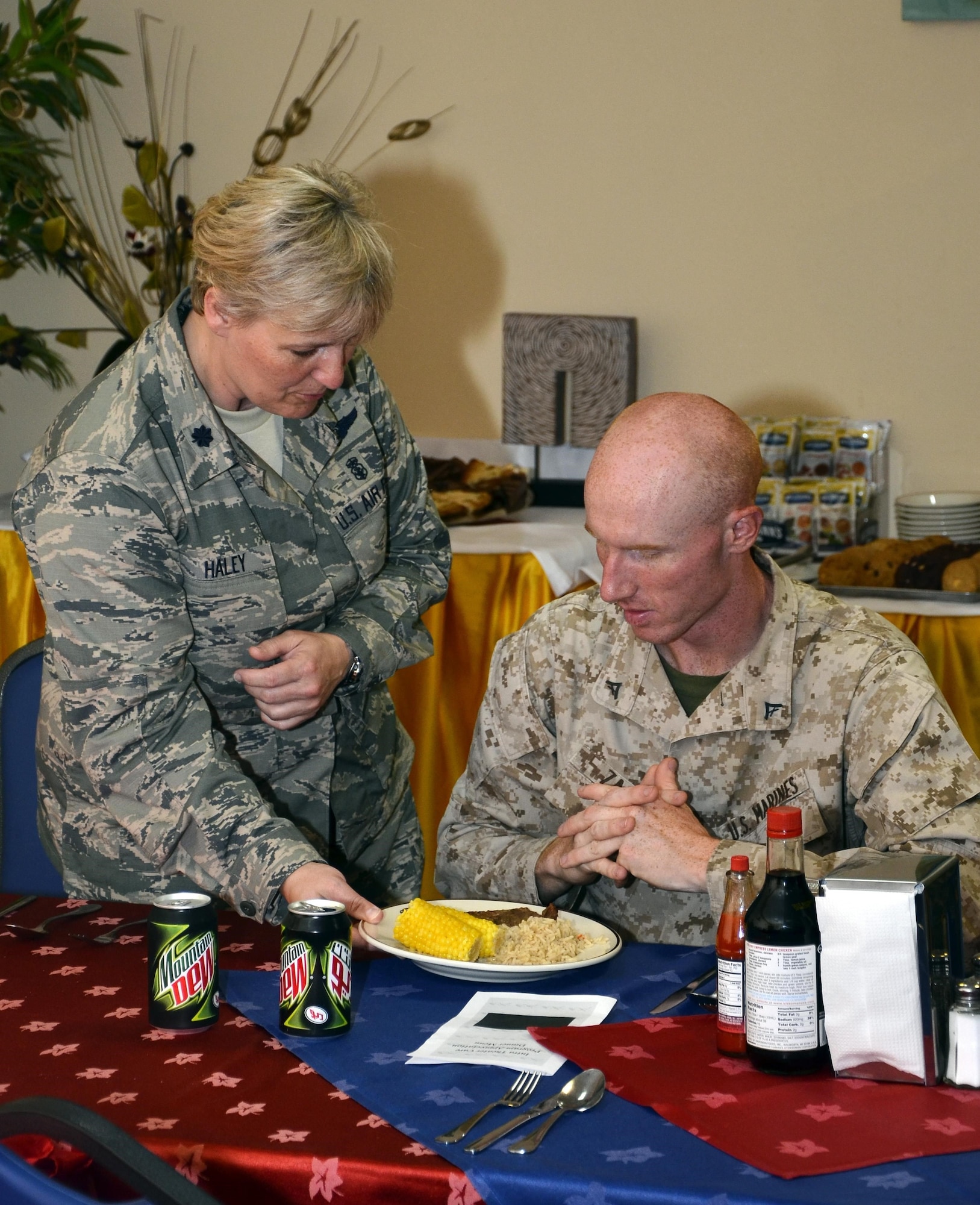 Lt. Col. Rosemary Haley serves dinner to Marine Lance Cpl. Matt Zager during a monthly Intra-Theater Care Program meal July 17, 2013, at the 379th Air Expeditionary Wing in Southwest Asia. Haley is the 379th Expeditionary Medical Group deputy commander and Zager is an ITCP patient. 