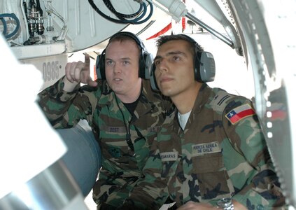 Staff Sgt. Bryon Best, left, an F-16 crew chief assigned to the 162nd Fighter Wing in Tucson, goes over maintenance issues with Chilean Air Force exchange officer 1st Lt. Cristobal Desmaras.