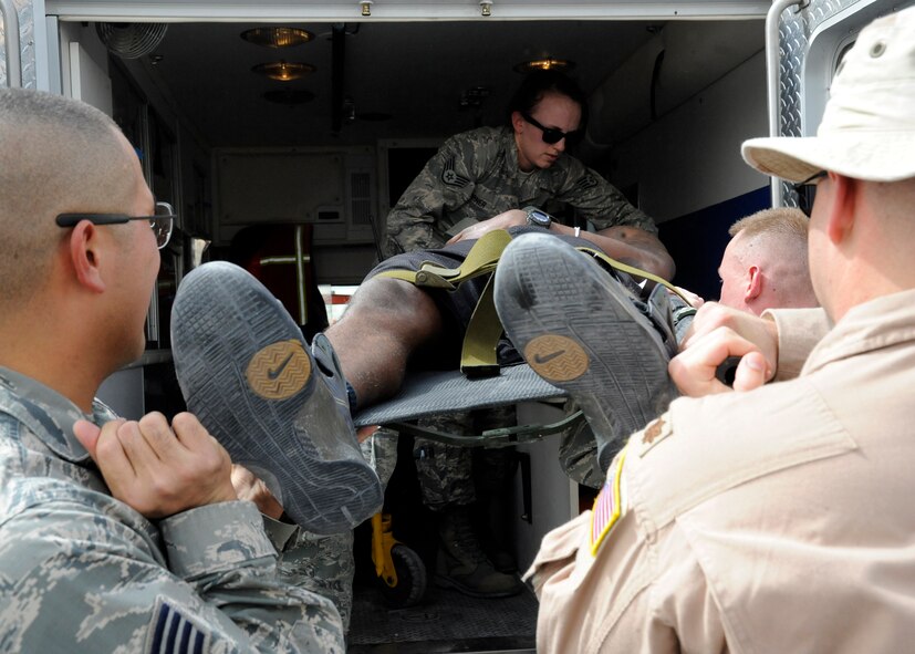 Emergency response Airmen place a casualty into an ambulance during a 379th Expeditionary Medical Group mass casualty exercise at the 379th Air Expeditionary Wing in Southwest Asia, July 26, 2013. The mass casualty exercise allowed the 379th EMDG to test their full medical response capabilities. (U.S. Air Force photo/Senior Airman Bahja J. Jones) 