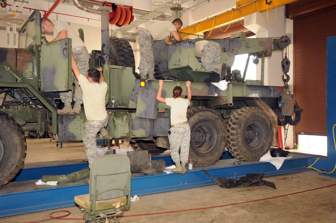 Airmen from the 200th RED HORSE Squadron Ohio Air National Guard, restore an M-900 Series Wrecker August 1, 2013, on Andersen Air Force Base, Guam. More than 40 Airmen helped Andersen with services, vehicle maintenance and supply during a temporary duty assignment here. (U.S. Air Force photo by Airman 1st Class Amanda Morris/Released)