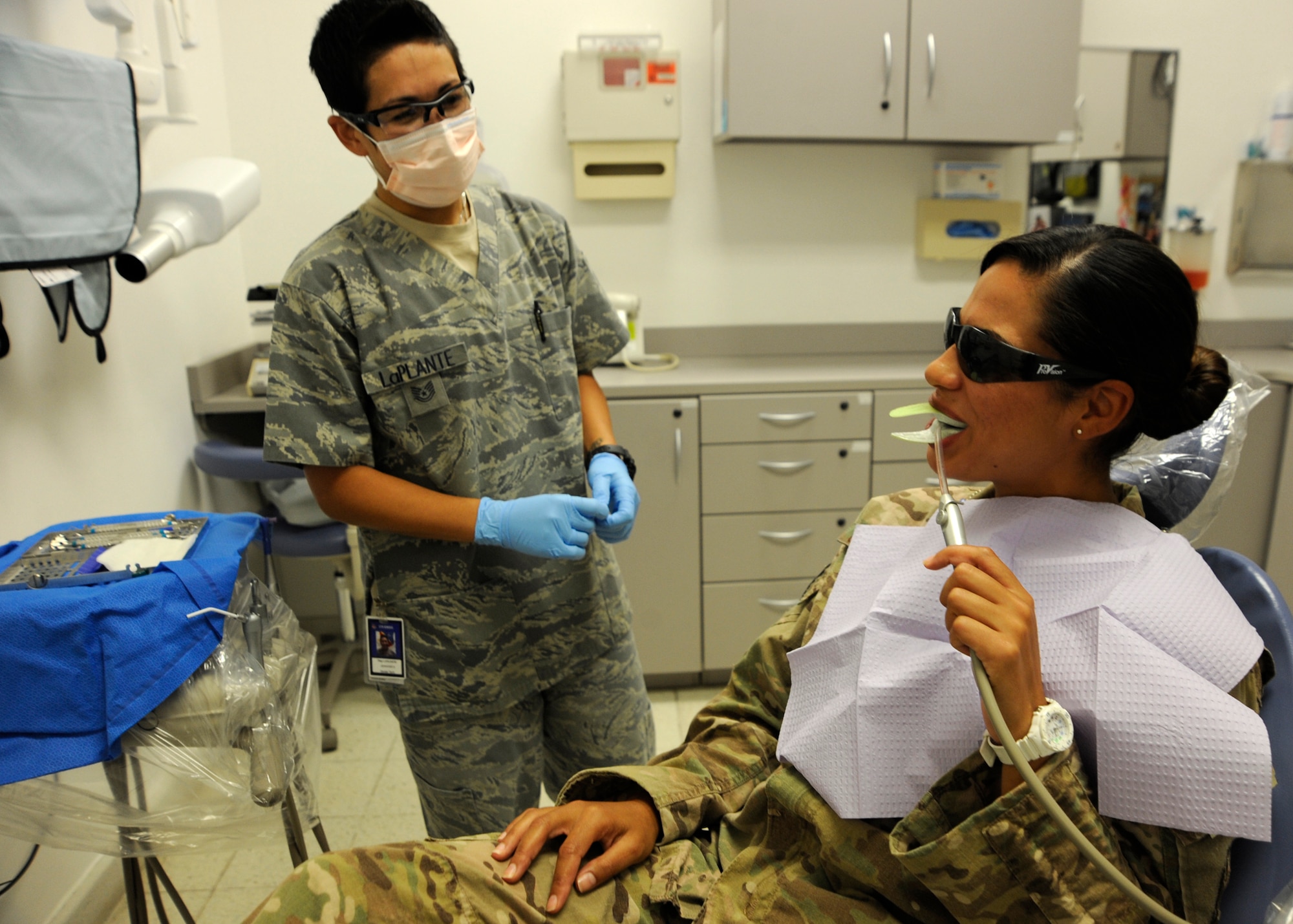 Tech. Sgt. Angela Quinones receives a fluoride treatment administered by Tech. Sgt. Jennifer LaPlante at the 379th Air Expeditionary Wing in Southwest Asia, July 29, 2013. Quinones is a 557th Expeditionary RED HORSE Squadron independent duty medical technician deployed from Malmstrom Air Force Base, Mont., and LaPlante is the 379th Expeditionary Medical Operations Squadron dental flight NCO in charge deployed from Hill Air Force Base, Utah. (U.S. Air Force photo/Senior Airman Bahja J. Jones) 

