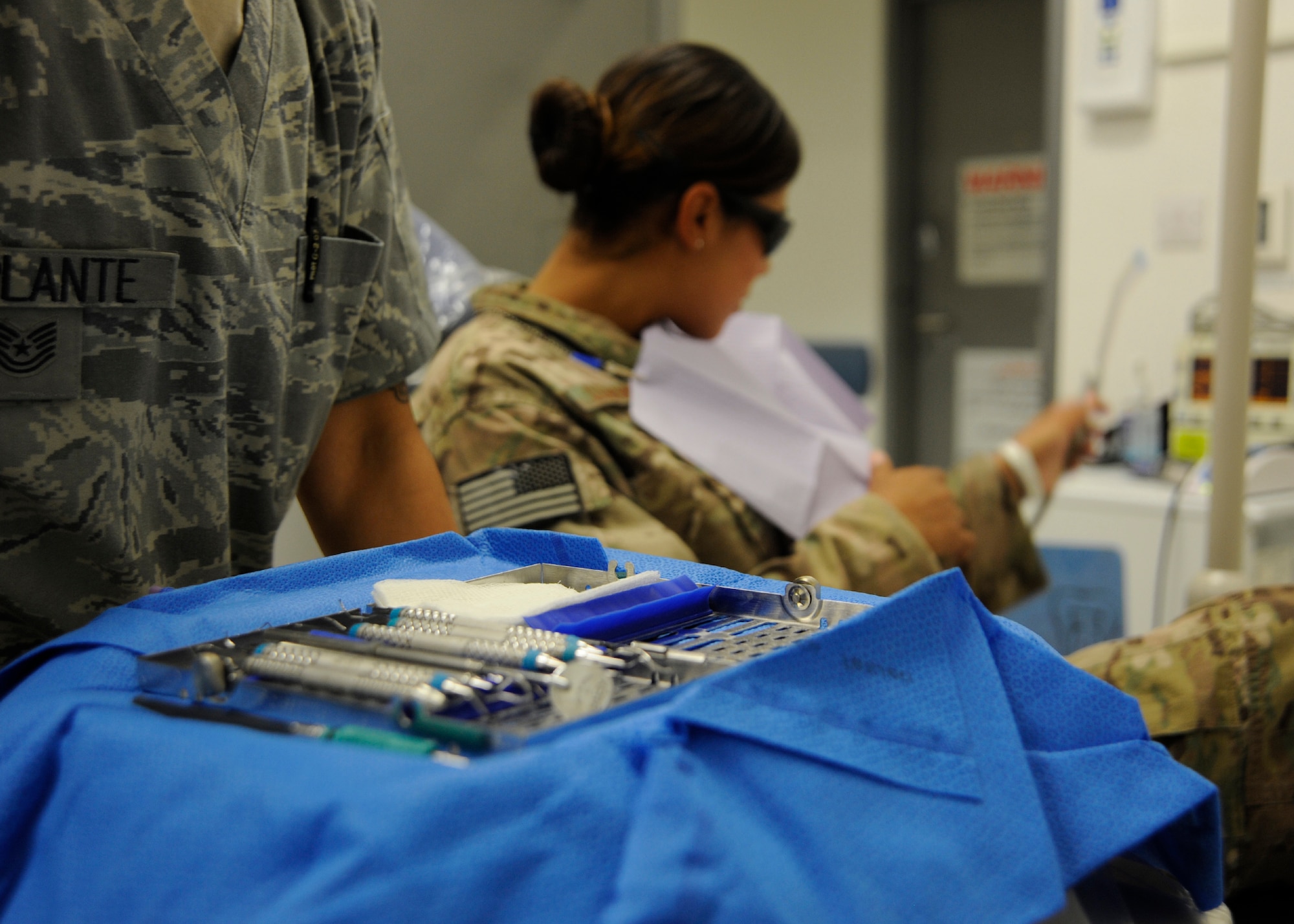 Capt. Jonathan Schubert examines Airman 1st Class Danielle Adams during a follow-up appointment at the 379th Air Expeditionary Wing in Southwest Asia, July 29, 2013. Schubert is the 379th Expeditionary Medical Operations Squadron dental services chief deployed from Hill Air Force Base, Utah, and Adams is a 557th Expeditionary RED HORSE Squadron vehicle maintainer deployed from Malmstrom Air Force Base, Mont. (U.S. Air Force photo/Senior Airman Bahja J. Jones) 