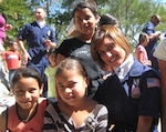 Tech. Sgt. Chandra Smith visits with children in Honduras during Tops in Blue's performance at Soto Cano Air Base in January. The team's visit to three Honduran orphanages was the highlight of Smith's tour with the Air Force expeditionary entertainment group.