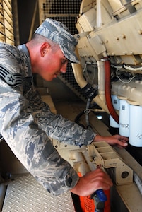 Air Force Staff Sgt. Jason Stephens of the West Virginia Air National Guard performs an inspection on the current generators being used at Joint Task Force Guantanamo's Camp Justice, March 25, 2009. The 474th ECES is here in support of the sustainment of Camp Justice and the Expeditionary Legal Complex.