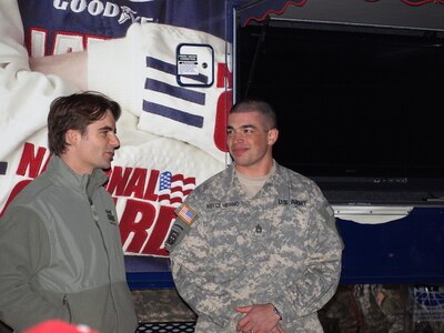 NASCAR driver Jeff Gordon talks with the Army's NCO of the Year Staff Sgt. Noyce Merino of the Montana Army National Guard before his race April 5 at the Texas Motor Speedway. Gordon and the Dupont/National Guard GED Car took first place in the race, snapping a winless streak for the racer.