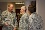 Air Force Gen. Craig McKinley (left), chief of the National Guard Bureau, talks with his executive officer, Army Col. Patrick Tennis, during U.S. Transportation Command's Reserve Component Chiefs and Adjutants General Conference held March 31 to April 2 at Scott Air Force Base, Ill.